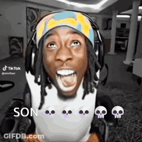 A Man In A Wheelchair Is Wearing Headphones And A Headband With Skulls On It And Says Son GIF
