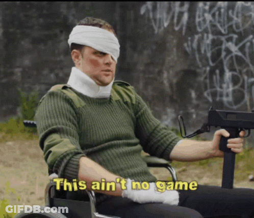 A Man In A Wheelchair With A Bandage On His Head Holds A Gun And Says This Ain T No Game GIF