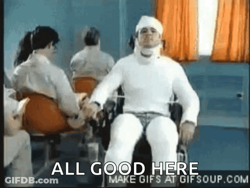 A Man In A Wheelchair With A Bandage On His Head Is Shaking Hands With Another Man . GIF