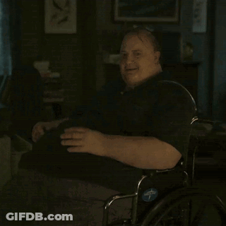 A Man In A Wheelchair With A Blue Sticker On The Wheel That Says ' Adaptive ' GIF