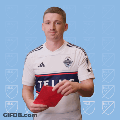 A Man In A White Adidas Shirt Holds A Red Card In His Hand GIF