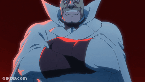 A Man In A White Cape With His Arms Crossed Looks At The Camera GIF