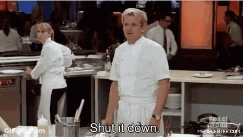 A Man In A White Chef 'S Coat Is Standing In A Kitchen . GIF