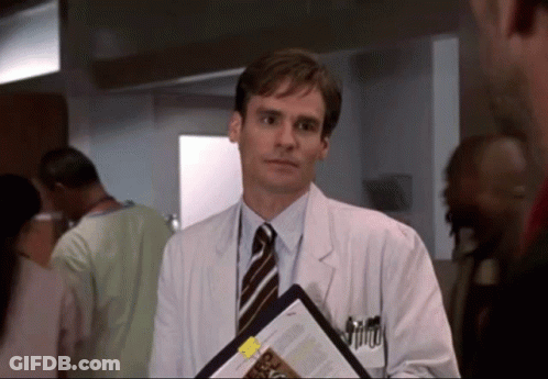 A Man In A White Coat And Tie Holds A Clipboard With A Yellow Sticker That Says ' A ' On It GIF