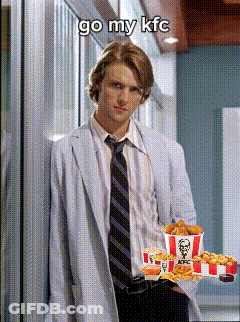 A Man In A White Coat And Tie Is Holding A Tray Of Kfc Fried Chicken GIF