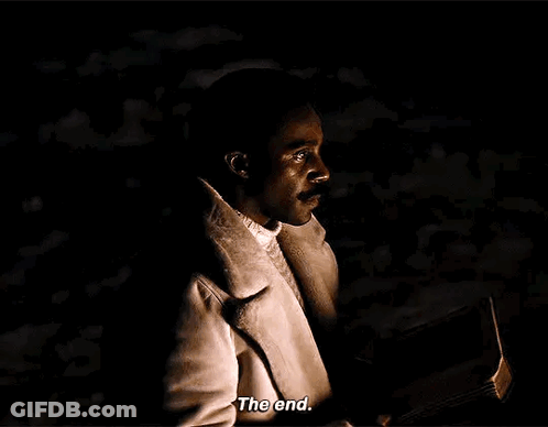 A Man In A White Coat Is Holding A Book In His Hand And Says `` The End '' . GIF