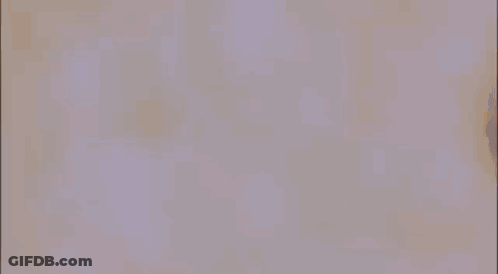 A Man In A White Coat Is Standing In A Crowd Of People . GIF