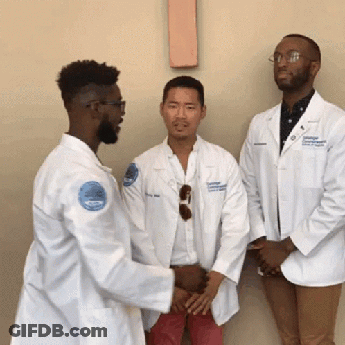 A Man In A White Coat With A Badge That Says ' University Of Connecticut ' On It GIF