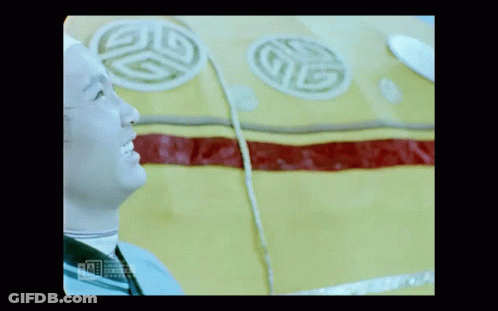 A Man In A White Hat Is Smiling In Front Of A Yellow And Red Item With A G On It GIF