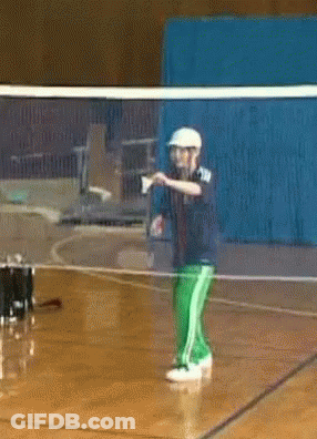 A Man In A White Hat Is Standing In Front Of A Volleyball Net GIF