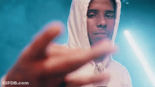 A Man In A White Hoodie Is Giving The Middle Finger . GIF