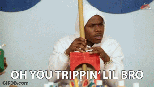 A Man In A White Hoodie Is Holding A Wooden Stick And The Words Oh You Trippin ' Lil Bro Are Above Him GIF