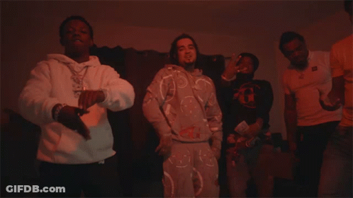 A Man In A White Hoodie With A Necklace That Says ' Snoop Dogg ' On It Is Dancing GIF
