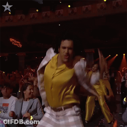 Man In White Jacket Dancing In Front Of Crowd GIF