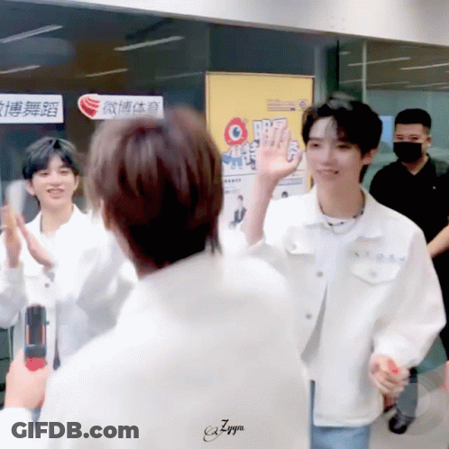 A Man In A White Jacket Is Giving A High Five GIF