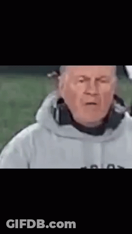 A Man In A White Jacket Is Making A Funny Face With His Eyes Closed . GIF