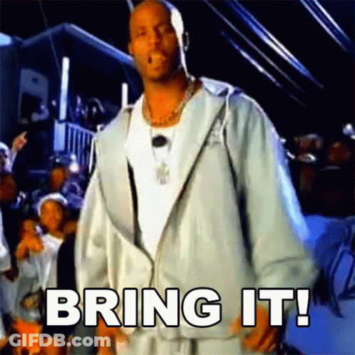 A Man In A White Jacket Is Standing In Front Of A Crowd With The Words Bring It Written On The Screen GIF