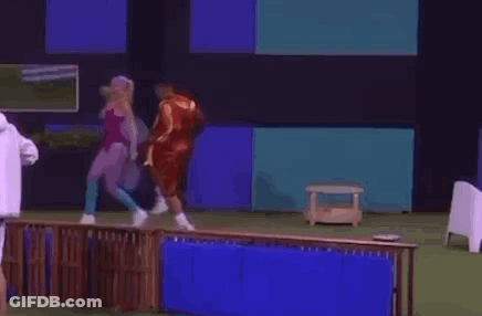 A Man In A White Jacket Is Standing Next To A Woman In A Pink Swimsuit . GIF