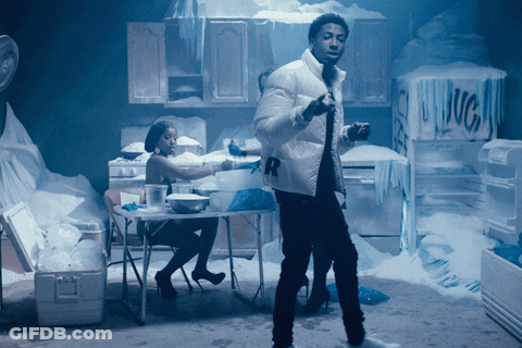 A Man In A White Jacket With The Letter R On It Stands In A Kitchen GIF