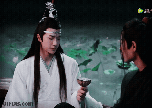A Man In A White Kimono Is Holding A Bowl In Front Of A Man In A Black Kimono GIF