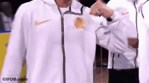 A Man In A White Nike Jacket Is Giving A Thumbs Up GIF