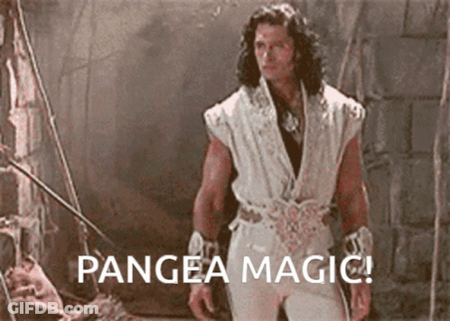 A Man In A White Outfit Is Standing In A Dark Room With The Words Pangea Magic Below Him GIF