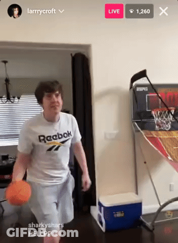 A Man In A White Reebok Shirt Is Playing Basketball GIF