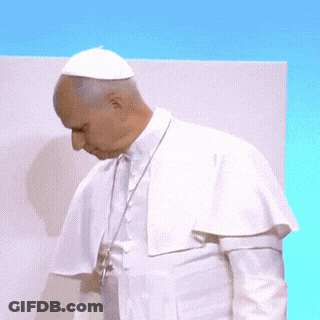 A Man In A White Robe Holds A Piece Of Paper In His Hands GIF