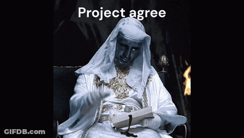 A Man In A White Robe Is Sitting In A Chair Reading A Book And Waving GIF