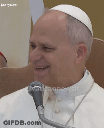 A Man In A White Robe Is Smiling In Front Of A Microphone With The Watermark Janey0406 GIF