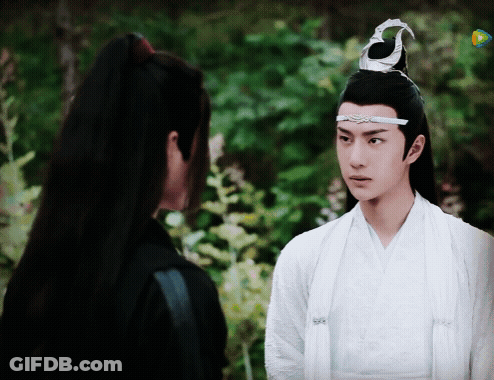 A Man In A White Robe Is Standing Next To A Man In A Black Shirt . GIF