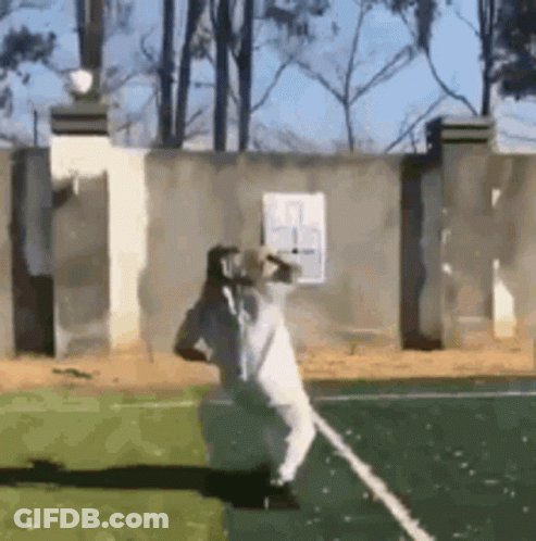 A Man In A White Robe Is Standing On A Tennis Court . GIF