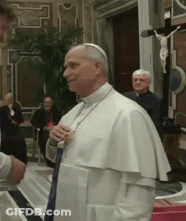 A Man In A White Robe Is Talking To Another Man GIF