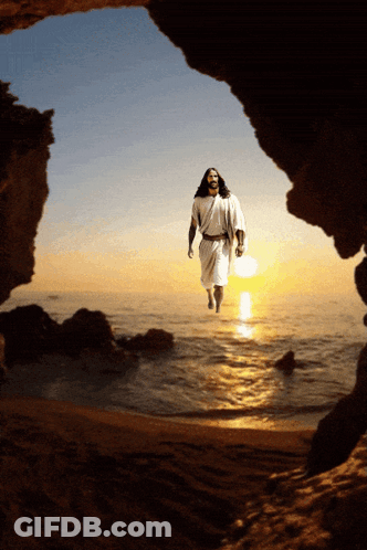 A Man In A White Robe Is Walking Out Of A Cave Into The Ocean GIF
