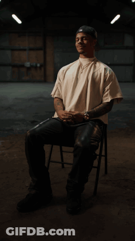 Man In White Shirt And Black Hat Sitting GIF