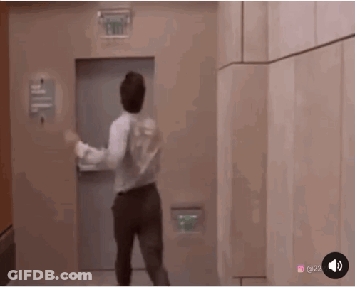 Man Dancing In Front Of Exit Sign GIF
