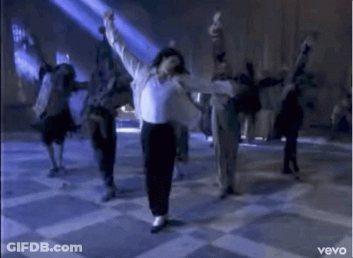 A Man In A White Shirt And Black Pants Is Dancing On A Checkered Floor With A Group Of People . GIF