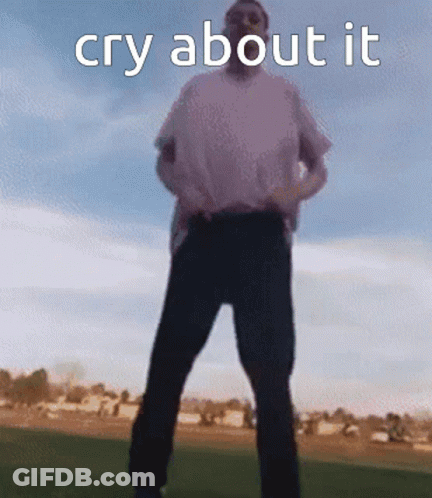 A Man In A White Shirt And Black Pants Is Standing In A Field With The Words Cry About It Above Him GIF