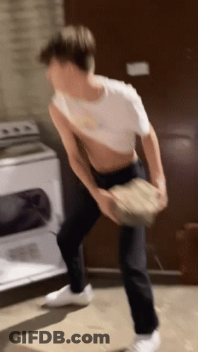 Man In White Shirt Standing By Washing Machine GIF