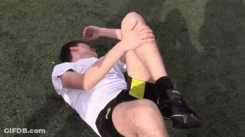 A Man In A White Shirt And Black Shorts With The Word Asics On The Side GIF
