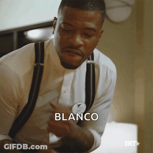A Man In A White Shirt And Black Suspenders Has The Word Blanco On His Chest GIF