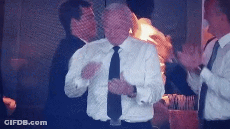A Man In A White Shirt And Black Tie Applauds GIF