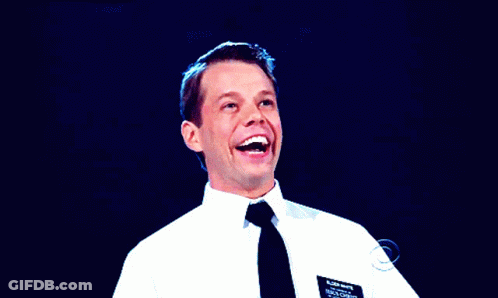 A Man In A White Shirt And Black Tie Has A Name Tag On His Chest That Says Brian Wright GIF