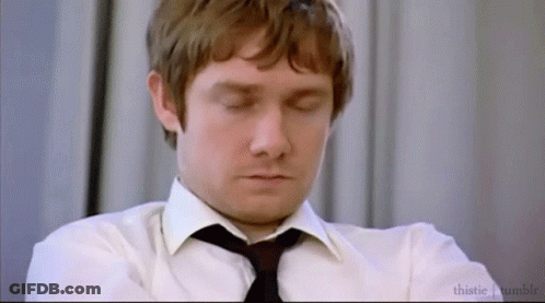 A Man In A White Shirt And Black Tie Is Sleeping With His Eyes Closed . GIF