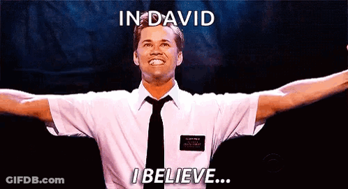 A Man In A White Shirt And Black Tie Is Standing With His Arms Outstretched And Says In David I Believe .. GIF