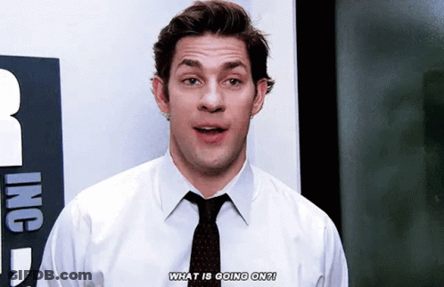 A Man In A White Shirt And Black Tie Is Talking About What Is Going On . GIF