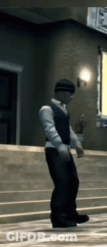 A Man In A White Shirt And Black Vest Is Standing On A Set Of Stairs GIF