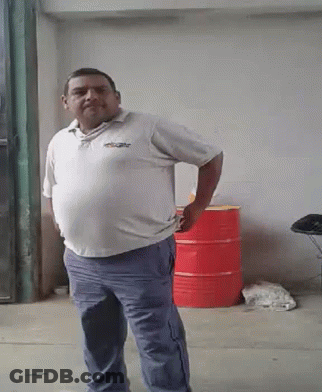 A Man In A White Shirt And Blue Pants Is Standing With His Hands On His Hips GIF