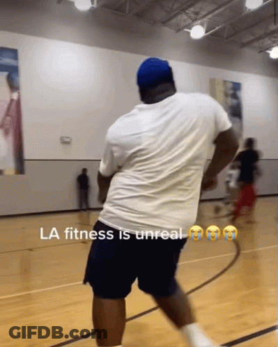 A Man In A White Shirt And Blue Shorts Is On A Basketball Court With The Caption La Fitness Is Unreal GIF