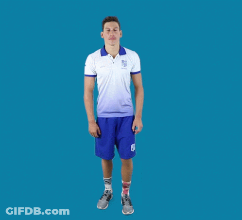 A Man In A White Shirt And Blue Shorts Stands In A Yoga Pose With His Arms Outstretched GIF